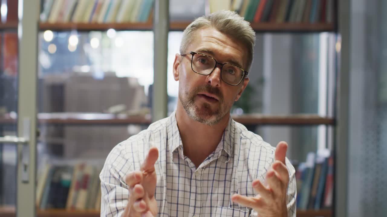 Video of caucasian businessman having video call in office