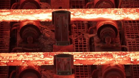 hot glowing steel travels over conveyor belt, close-up in a foundry industry