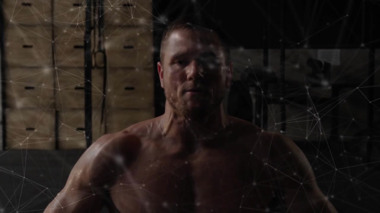 Man starting set lifting dumbbells on bench pressing while particles showing muscle for fitness
