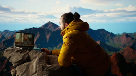 young ceo entering a video call from the mountain top with a strong signal