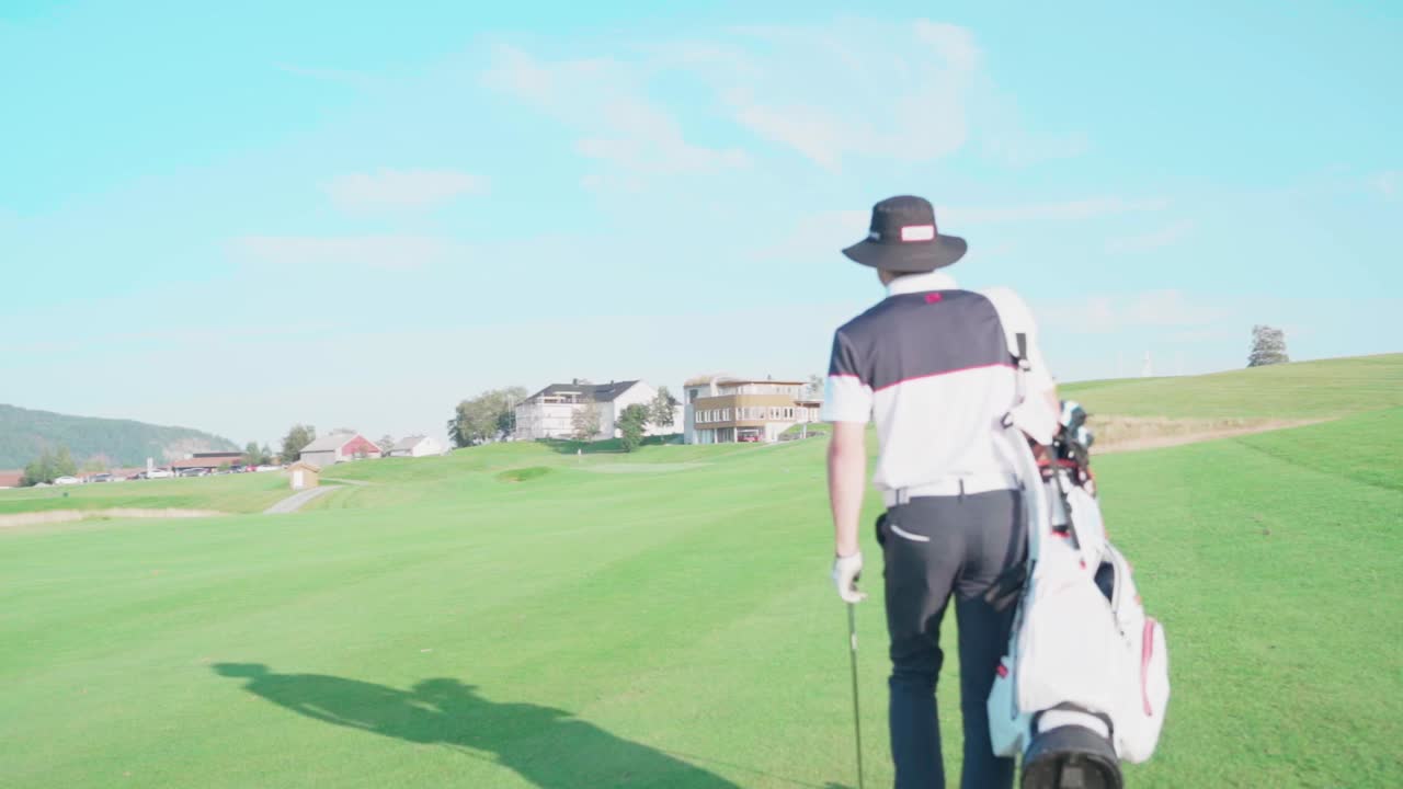Following golfer walking towards clubhouse