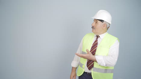 engineer looking at camera in amazement and making a presentation.