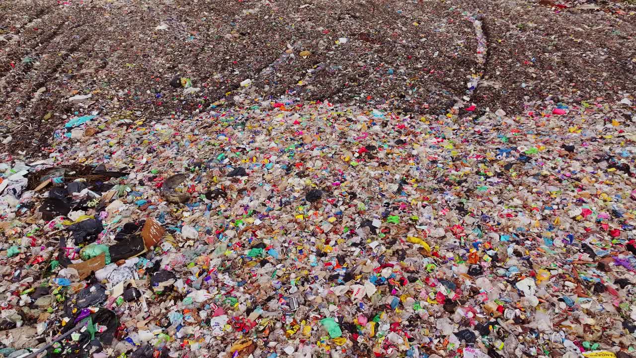Vast landfill site filled with plastic waste, mixed trash, environmental crisis
