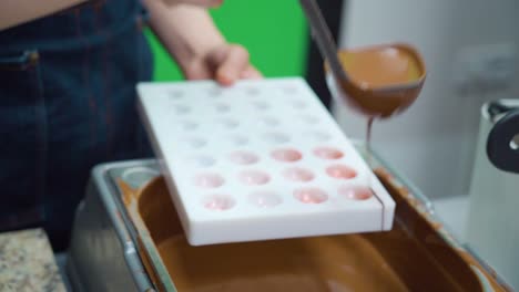 el chocolate fundido se coloca en moldes para confitería