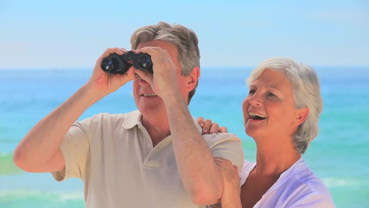 Elderly couple using binoculars