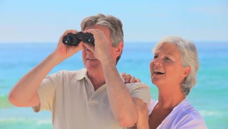 elderly couple using binoculars