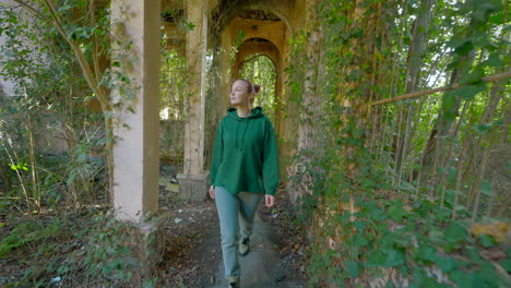 woman exploring abandoned ruins