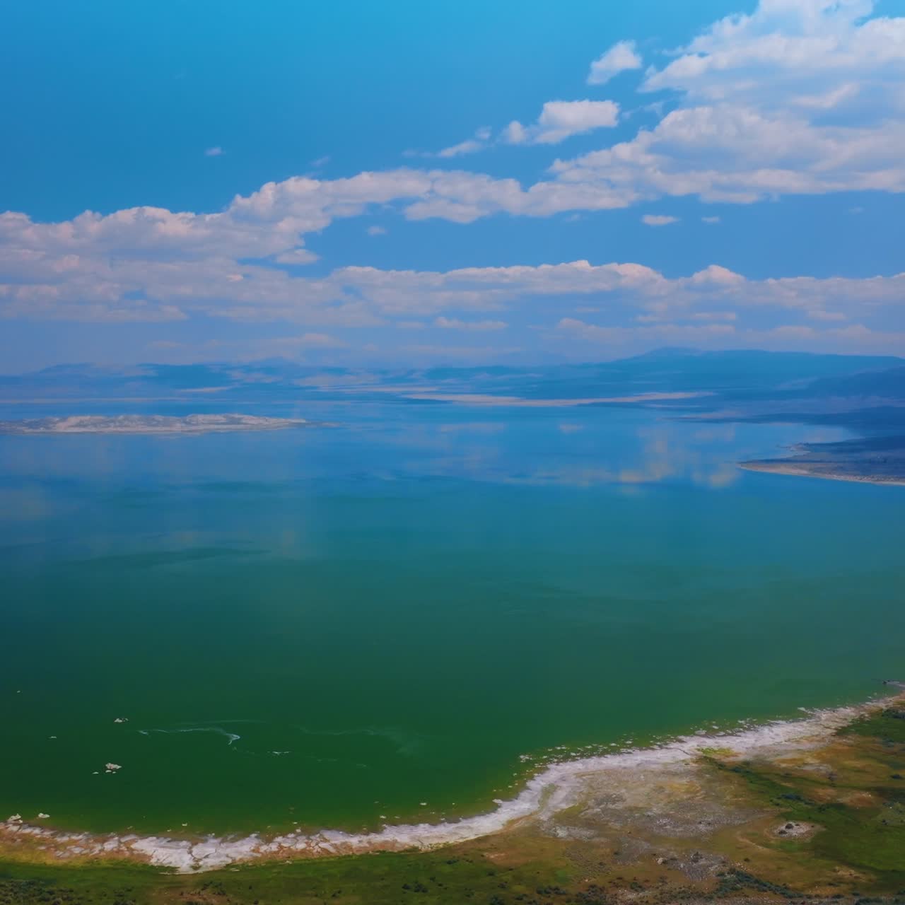 Mesmerizing turquoise scenery of lake joining with sky. Amazing saline soda Mono Lake in California from aerial perspective