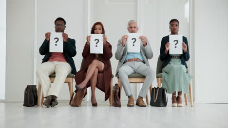 group of candidates holding question mark signs during job interview
