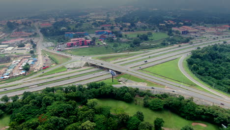 a high-altitude aerial parallax view of the modern highway system in abuja, nigeria