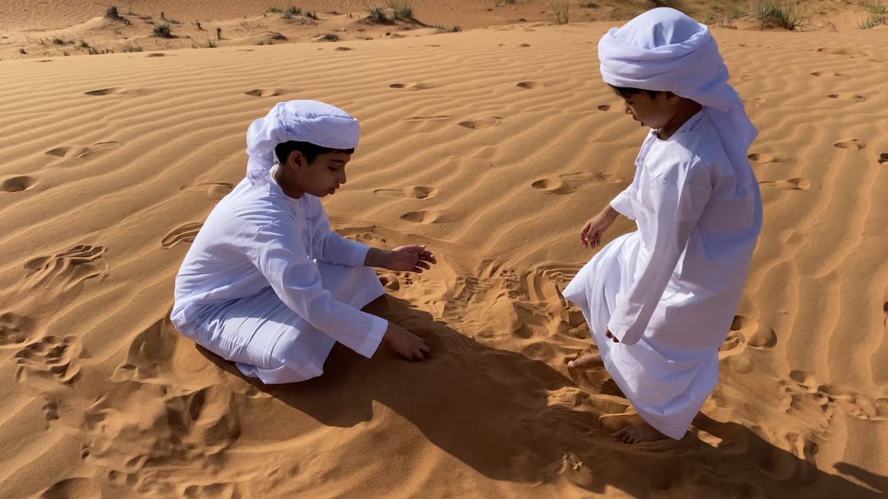 Two Emarati children playing in the desert