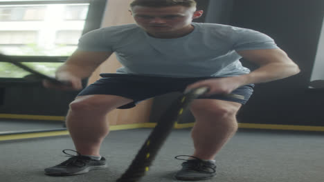 man doing battle rope exercise