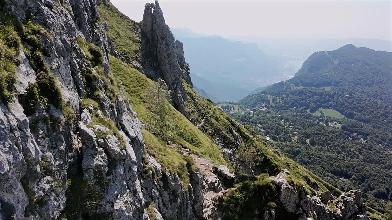 Drone flying over rocky mountains, summer season, sunlight, Alps, Italy, Aerial