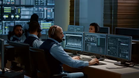 control room operations: professionals monitoring data on multiple screens