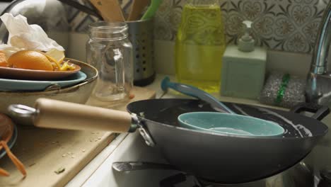 close up of dirty dishes and food leftovers in the kitchen sink