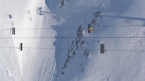 skiers on a sk lift from above