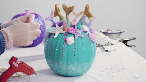 decorating art pumpkins in mermaid theme for halloween