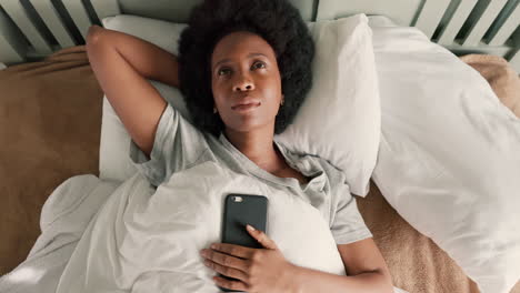 Thinking,-anxiety-and-woman-in-bedroom-with-phone