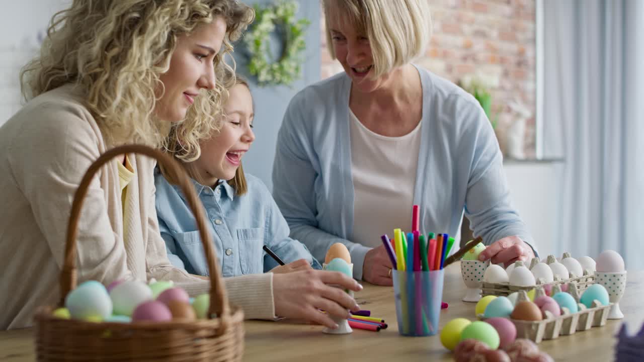 Video of happy family have fun during coloring Easter egg