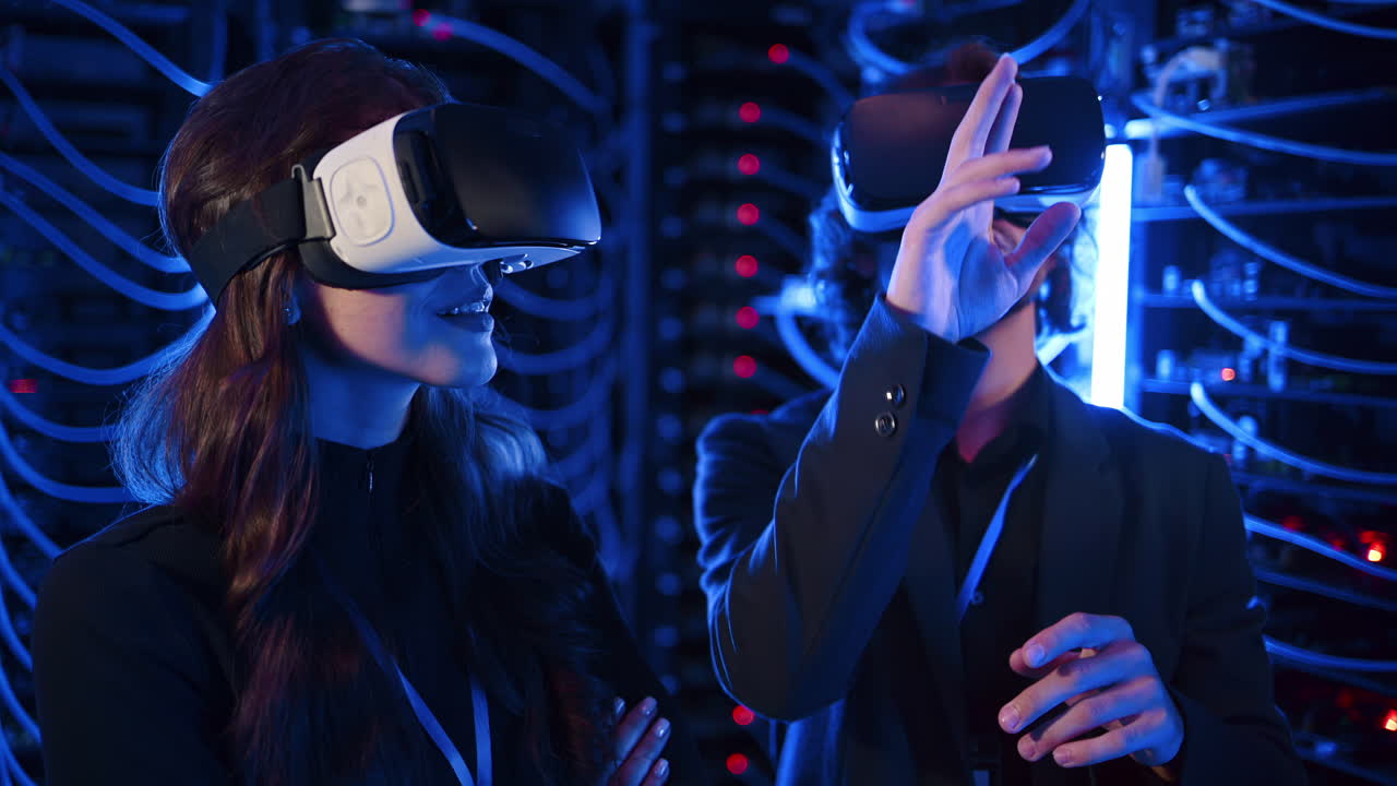 A man and a woman using Virtual Reality headsets in a server room