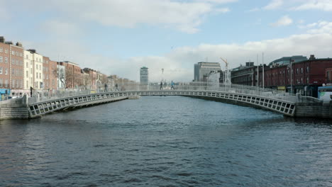 aerial pull back footage of the ha'penny bridge in dublin city