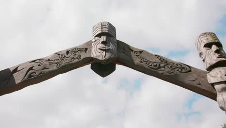 wooden totem arch gate against white sky