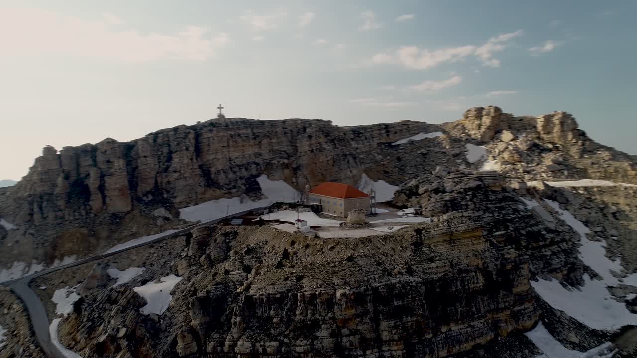 Magnificent panoramic aerial view of Akoura church with red roof nestled on top of mountain, Lebanon