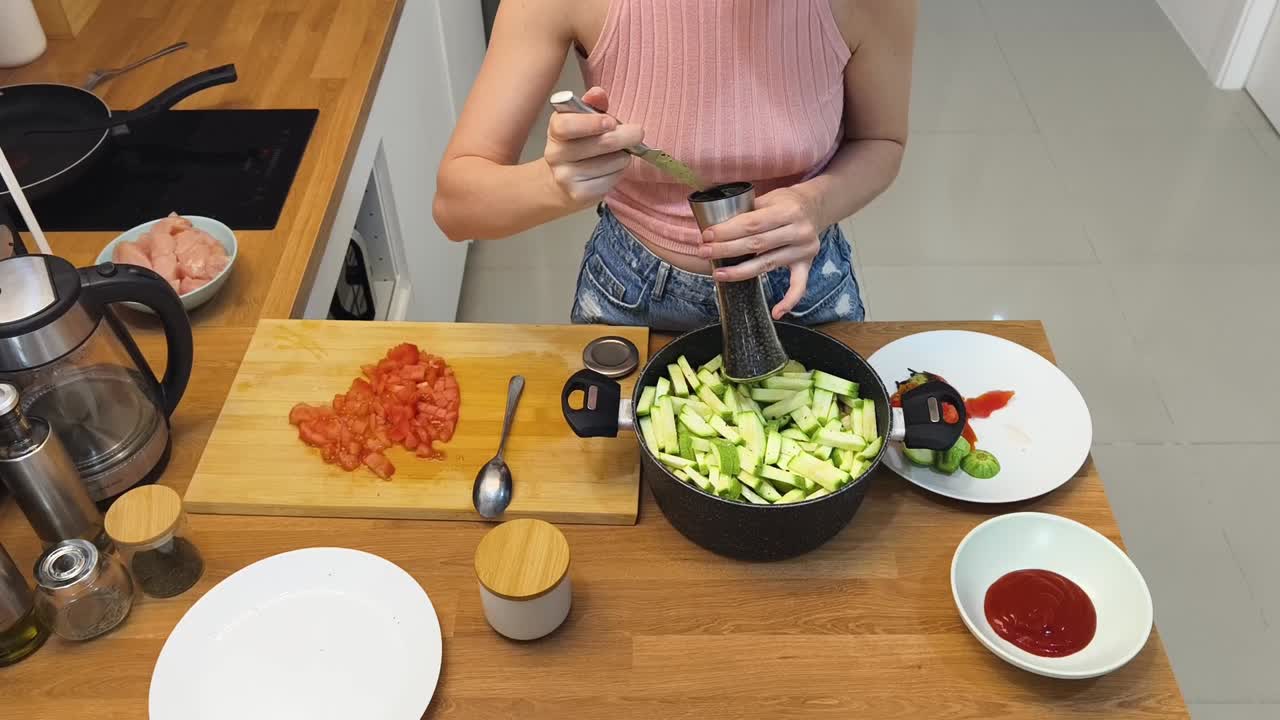 Preparing zucchini and tomato meal