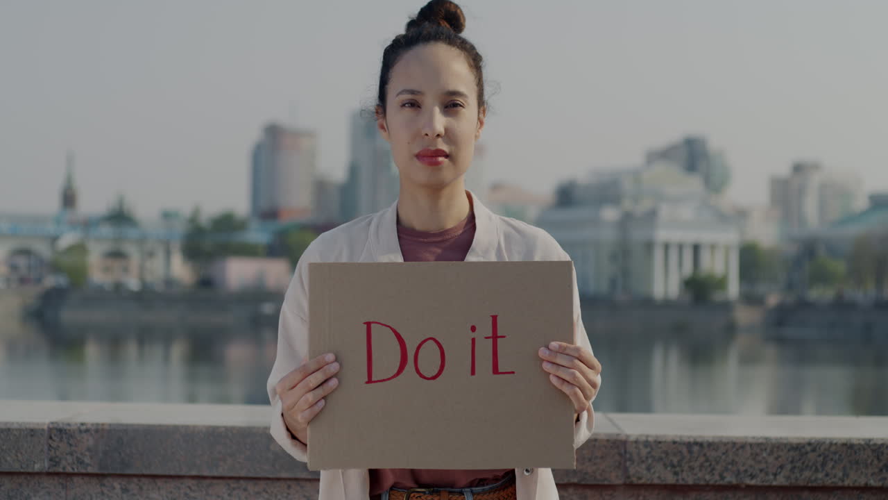 Woman Holding a Sign Saying "Do It"