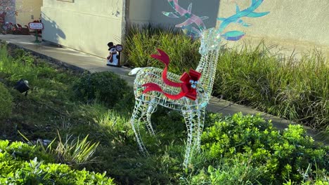 Magische-Rentier-weihnachtslichtskulptur,-Die-Tagsüber-In-Einem-üppigen-Grünen-Garten-Steht