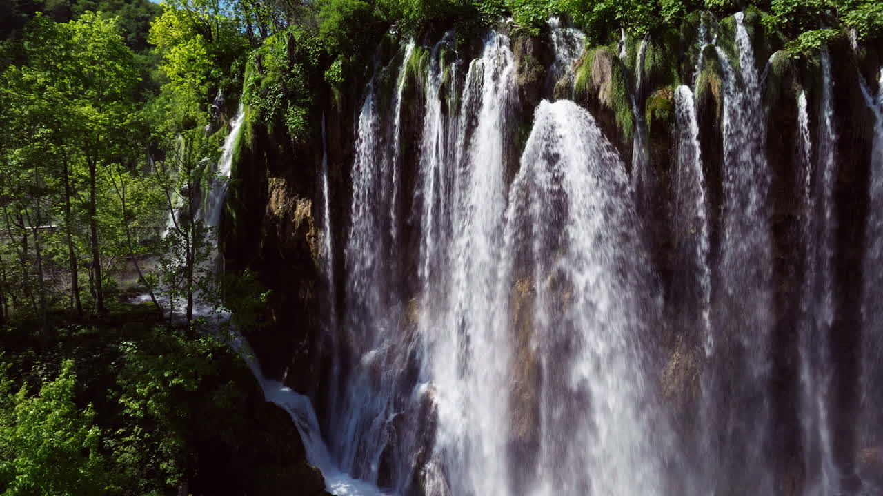 Closeup Of Water Flowing From Waterfalls At Plitvice Lakes National Park In Croatia. - aerial shot