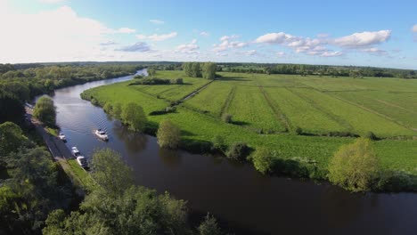 aerial drone footage of a boat sailing along the river yare, norfolk