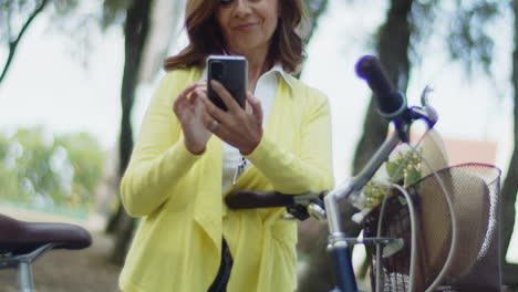 happy caucasian woman looking at phone screen and smiling