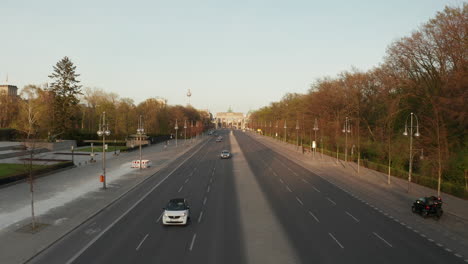 AERIAL:-Empty-Brandenburger-Tor-in-Berlin,-Germany-due-to-Coronavirus-COVID-19-Pandemic-in-Sunset-Light