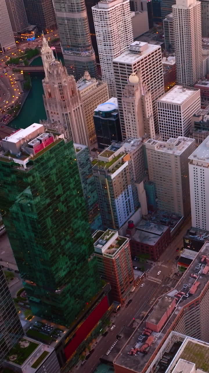 Modern beautiful high buildings of Chicago downtown. Vibrant city lighting lights in the evening. Top view. Vertical video