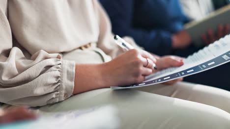person taking notes during a meeting