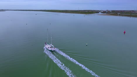 Flying-towards-yacht-on-calm-water-on-wide-river