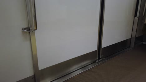 pov to the commuter train door while train is at platform in subway train station in tokyo in 4k slowmotion