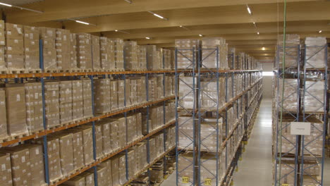 wide pan of high racks filled with boxes in warehouse