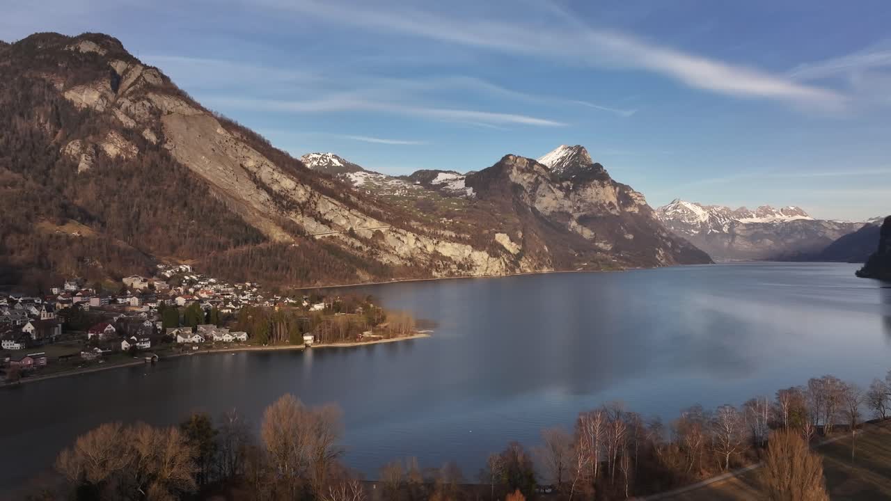 Panoramic view of Lake Walensee and the charming village of Weesen nestled along its shores, surrounded by the majestic Swiss Alps.