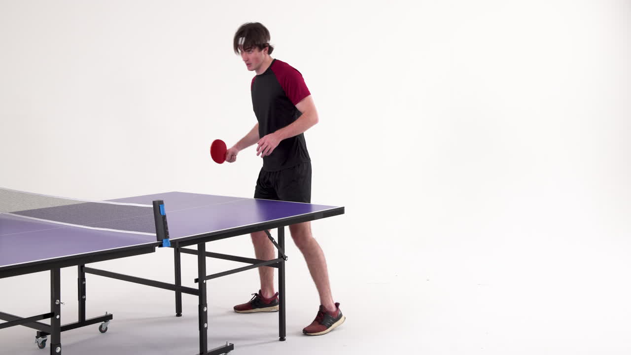 Playing table tennis, young man holding paddle and preparing to serve