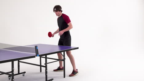 playing table tennis, young man holding paddle and preparing to serve
