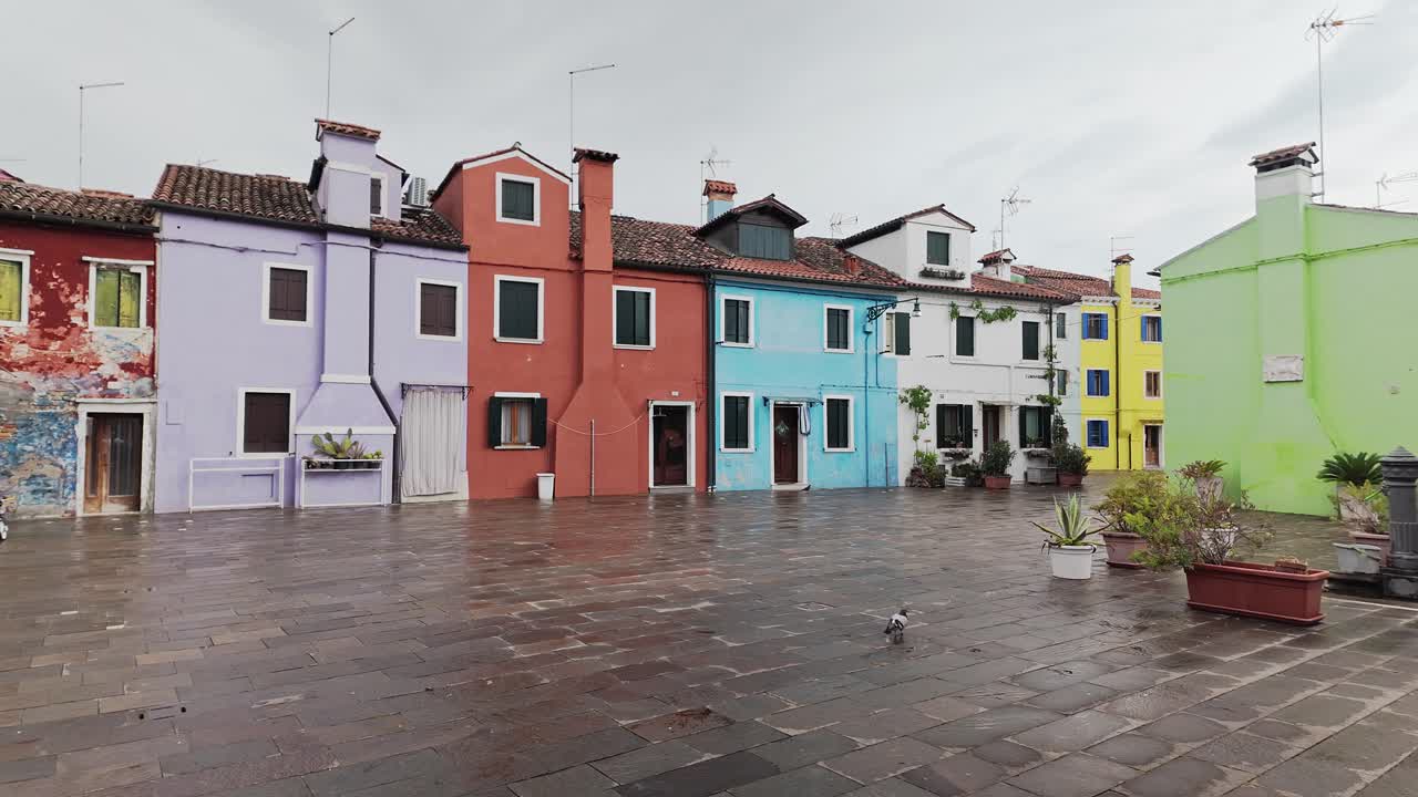 Colourful Painted fisherman's houses of Burano on rainy day. Wide pan