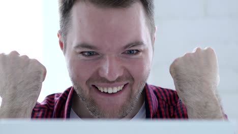 happy young man cheering success of project