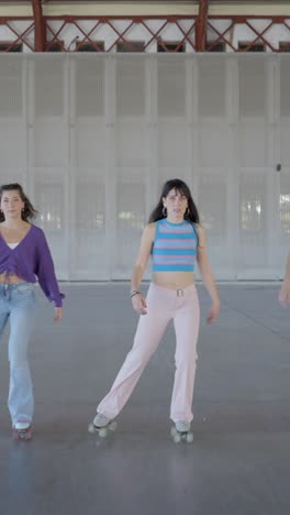young women enjoying roller skating indoors