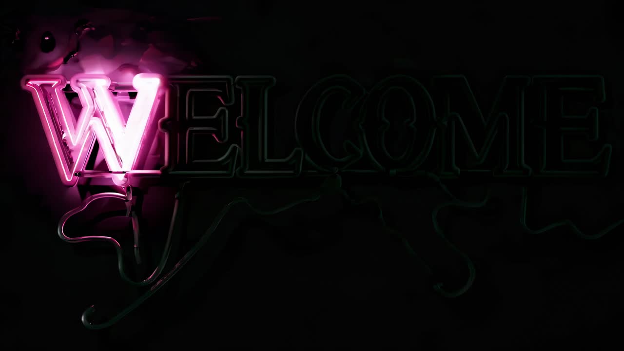 Neon pink 'Welcome' sign glowing against a dark background, captured from a straight-on angle