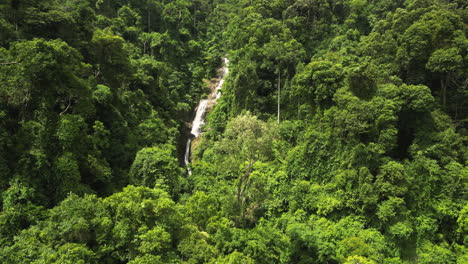 approaching aerial reveal of huay to waterfall in krabi, thailand