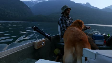 Fisherman-fishing-with-his-dog-in-the-river-4k