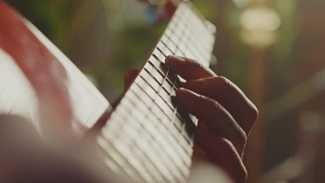 close up of person playing guitar