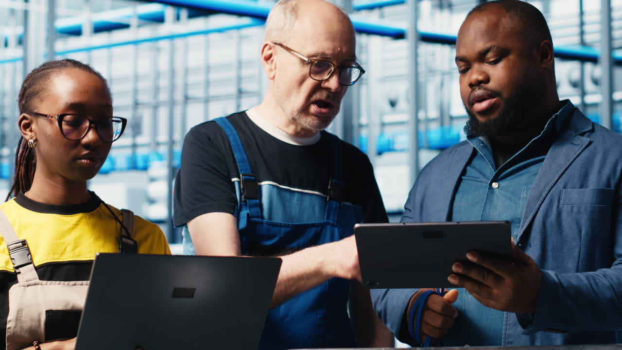 Engineers talk with manager overseeing smart factory, showing collected metrics